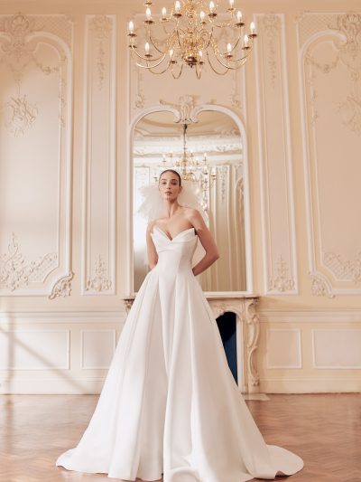 Mikado satin bridal gown with peaked neckline and textured fabric, by Ellis. Bridal Shop Northallerton