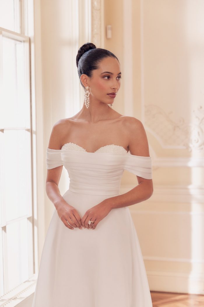 Organza off the shoulder, A-Line wedding dress with peekaboo pearl cups and beaded back, by Ellis.