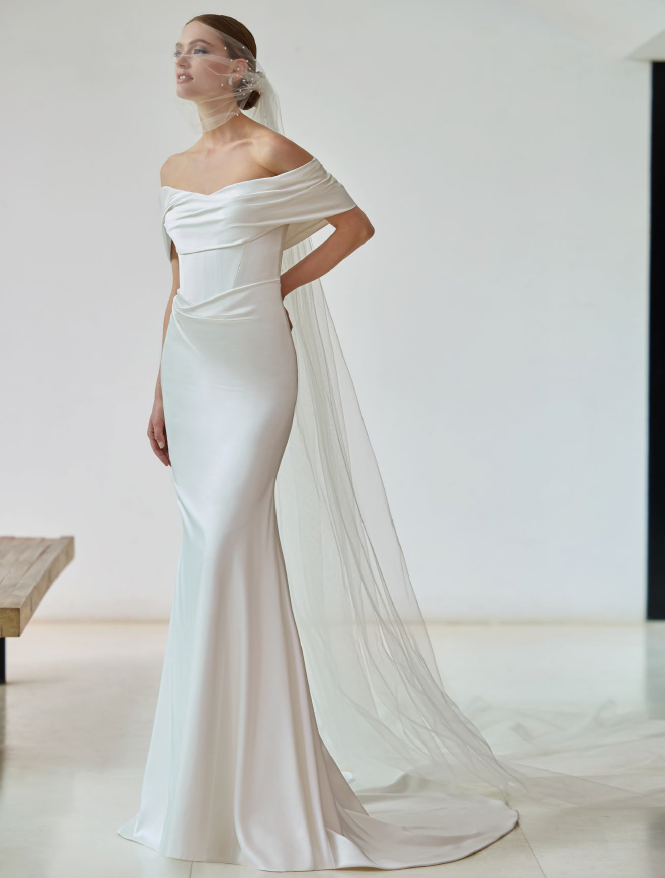 Fit and flare satin dress with off-the-shoulders neckline and basque waist bodice, by Pronovias Bridal Shop North East